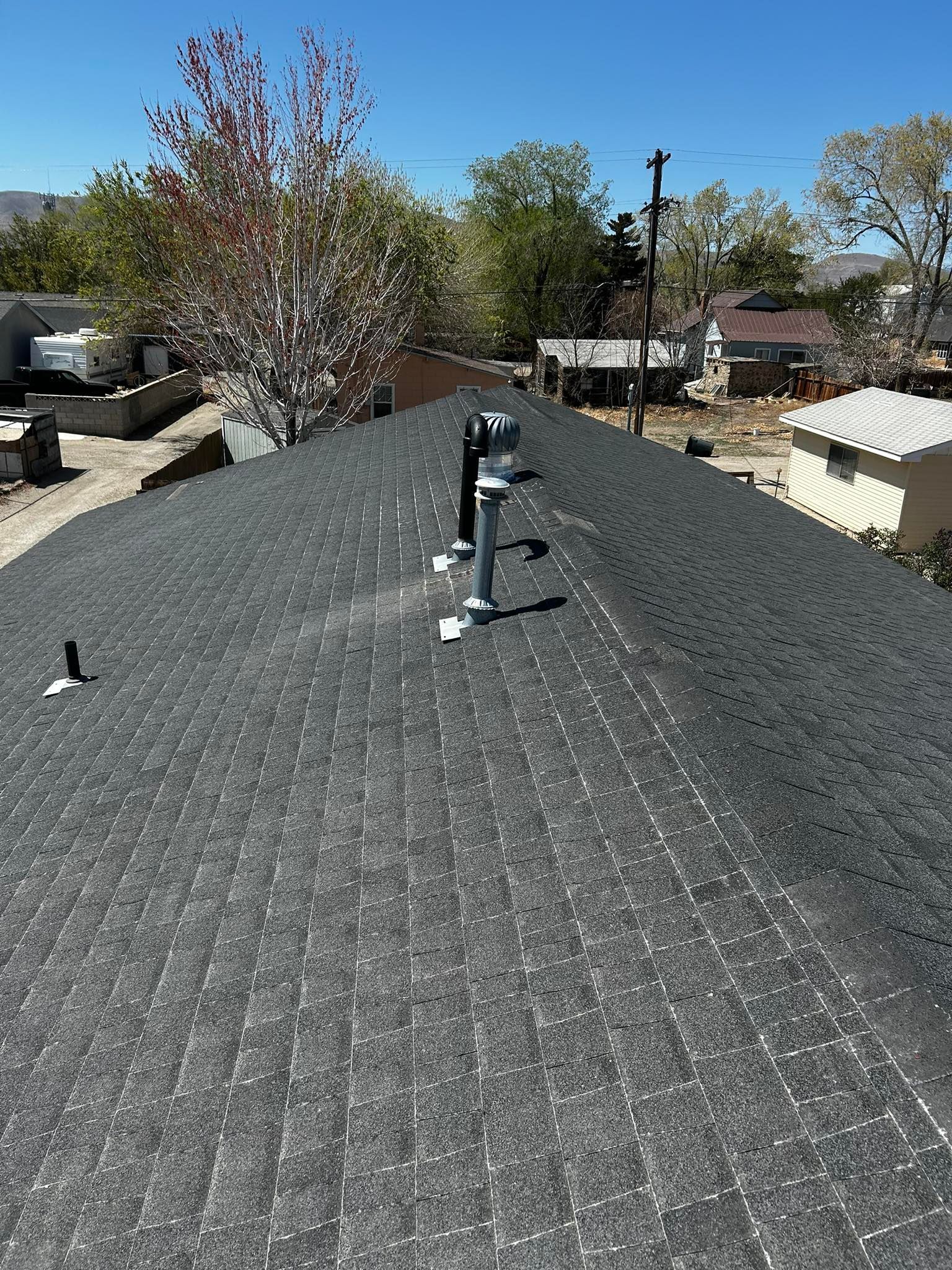 An aerial view of a snowy rooftop with a yellow stripe on it.
