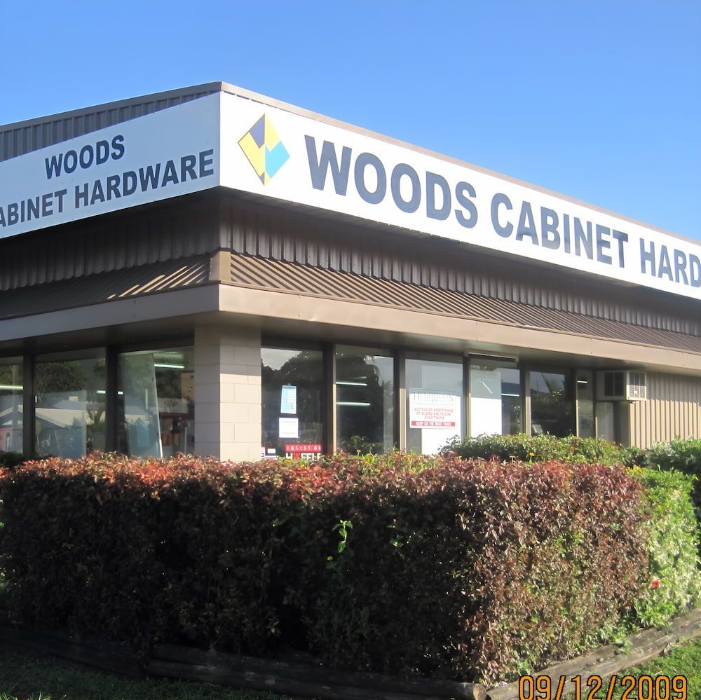 A Building With A Sign That Says Woods Cabinet Hardware — Wood Cabinet Hardware Distributors In Bungalow, QLD