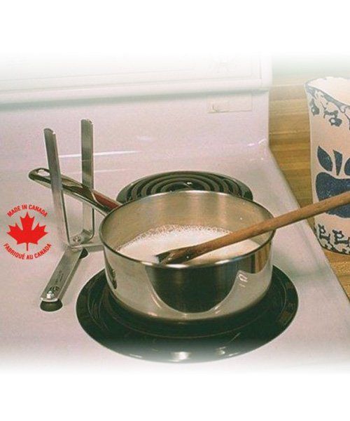 a pot of milk is on a stove with a canadian maple leaf on it