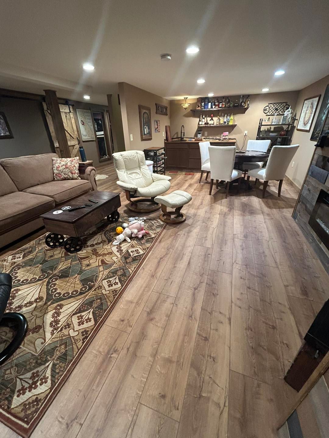 A living room with a couch , chair , table and rug.