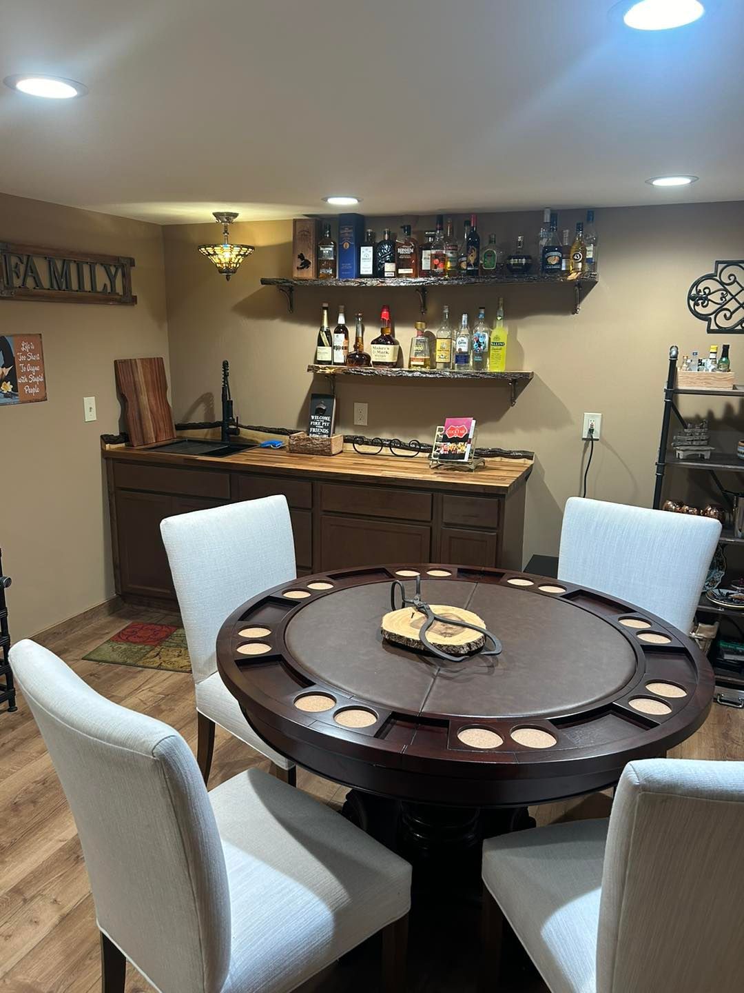 A game room with a table and chairs and a bar.