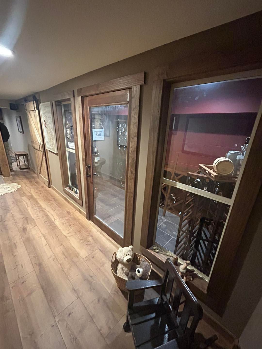 A hallway with hardwood floors and a lot of windows.