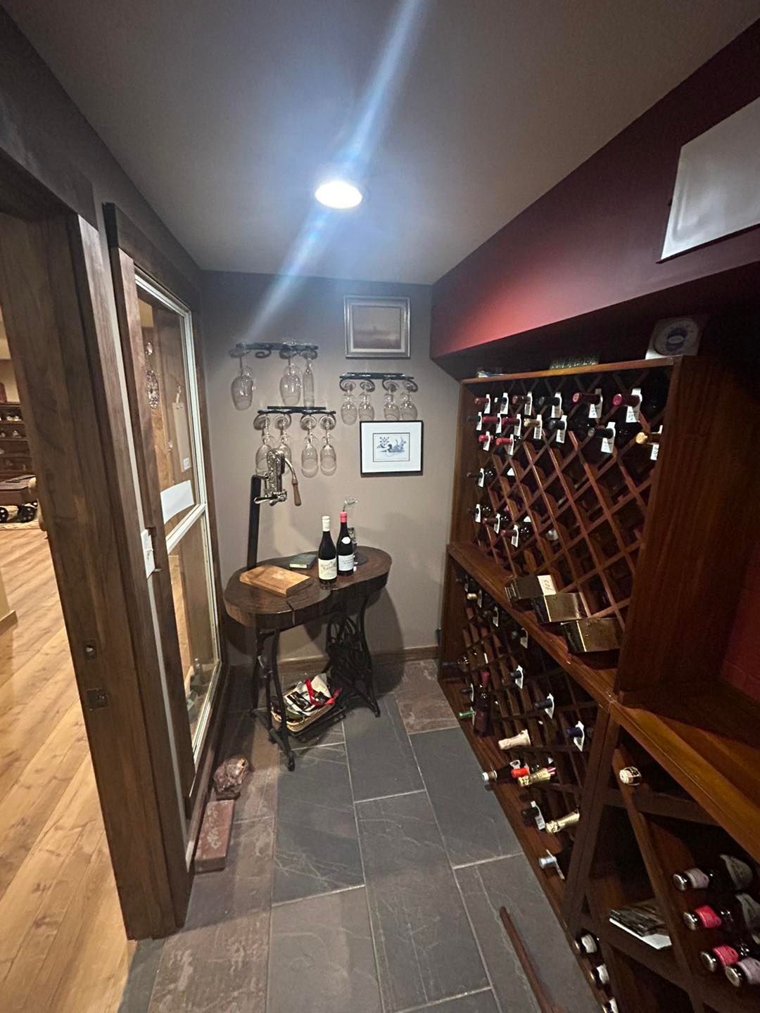 A wine cellar filled with lots of wine bottles and a table.