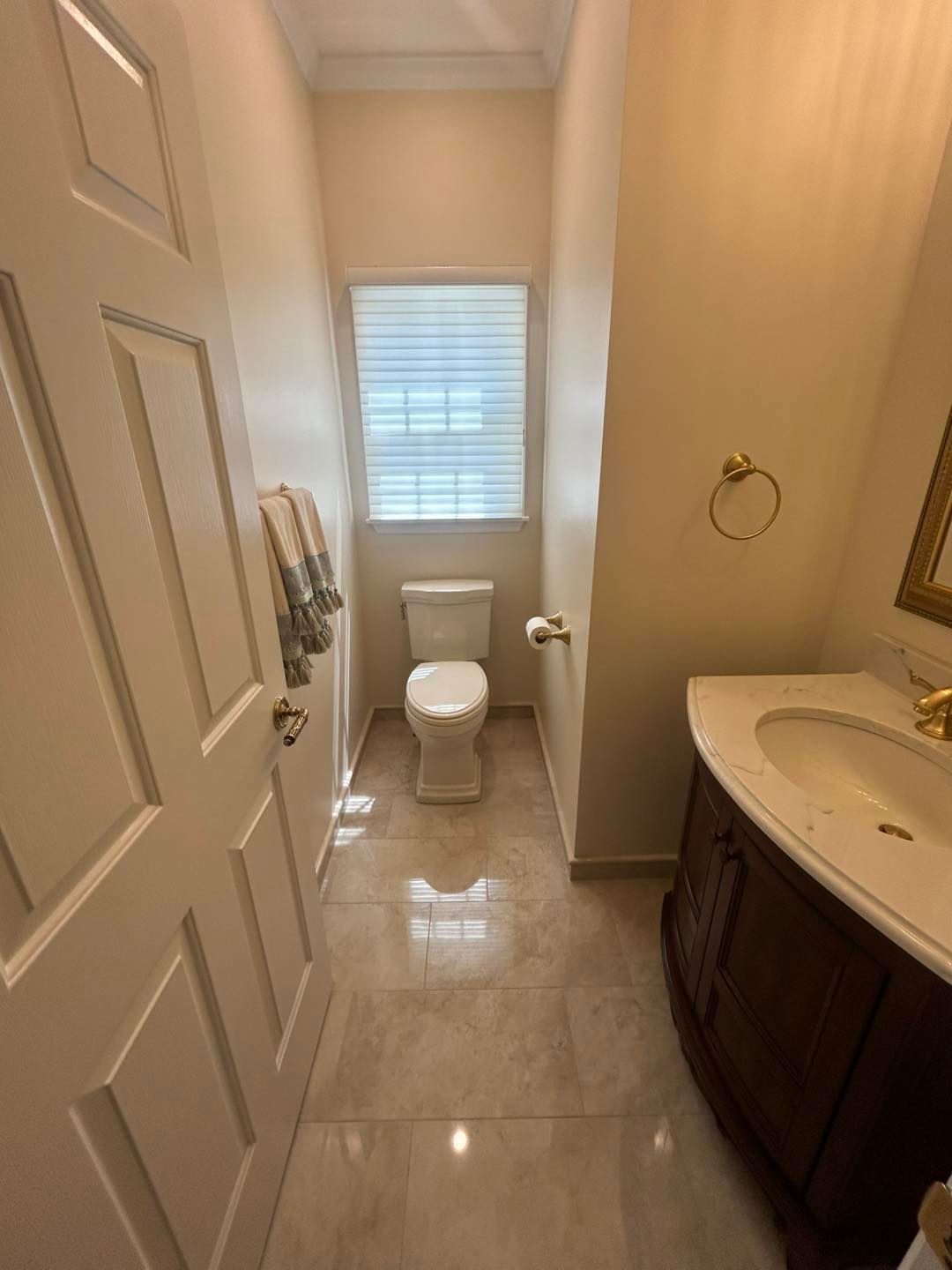 A bathroom with a toilet , sink and mirror.