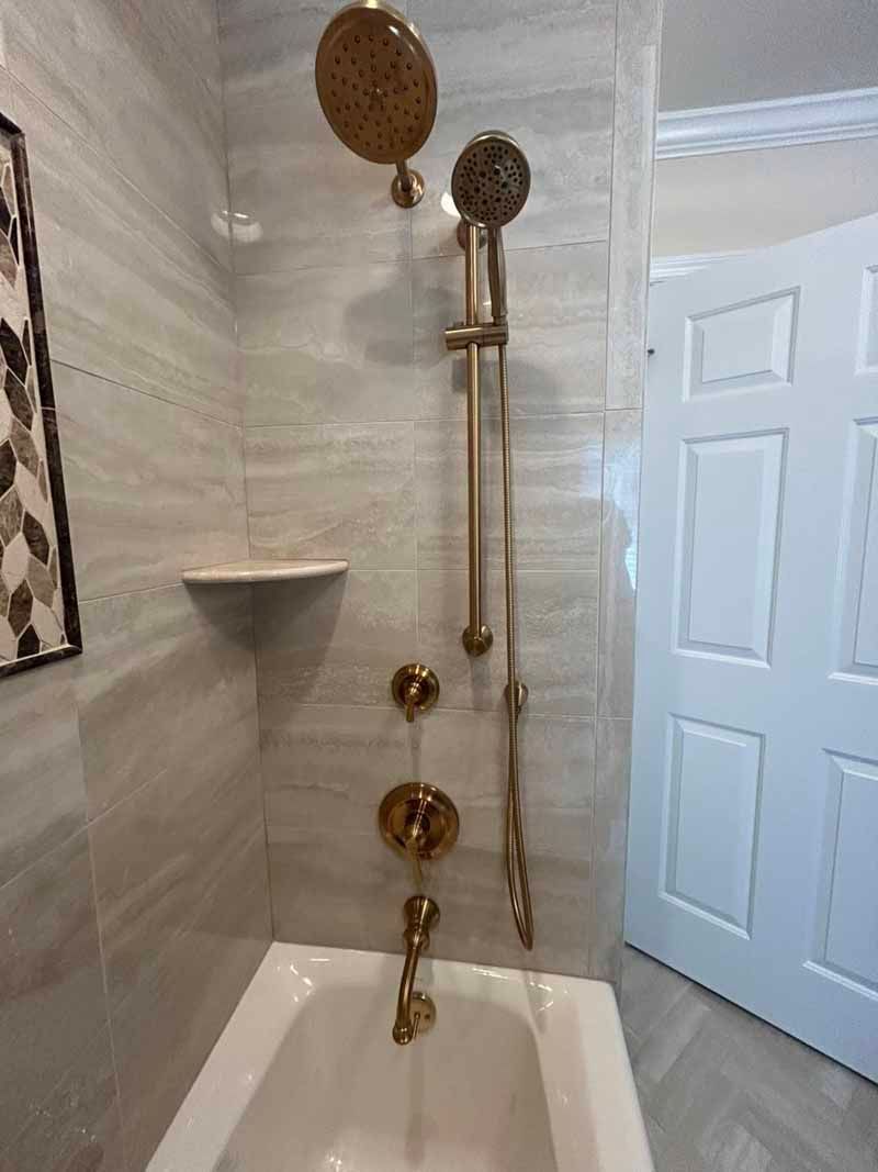 A bathroom with a bathtub and a shower head.