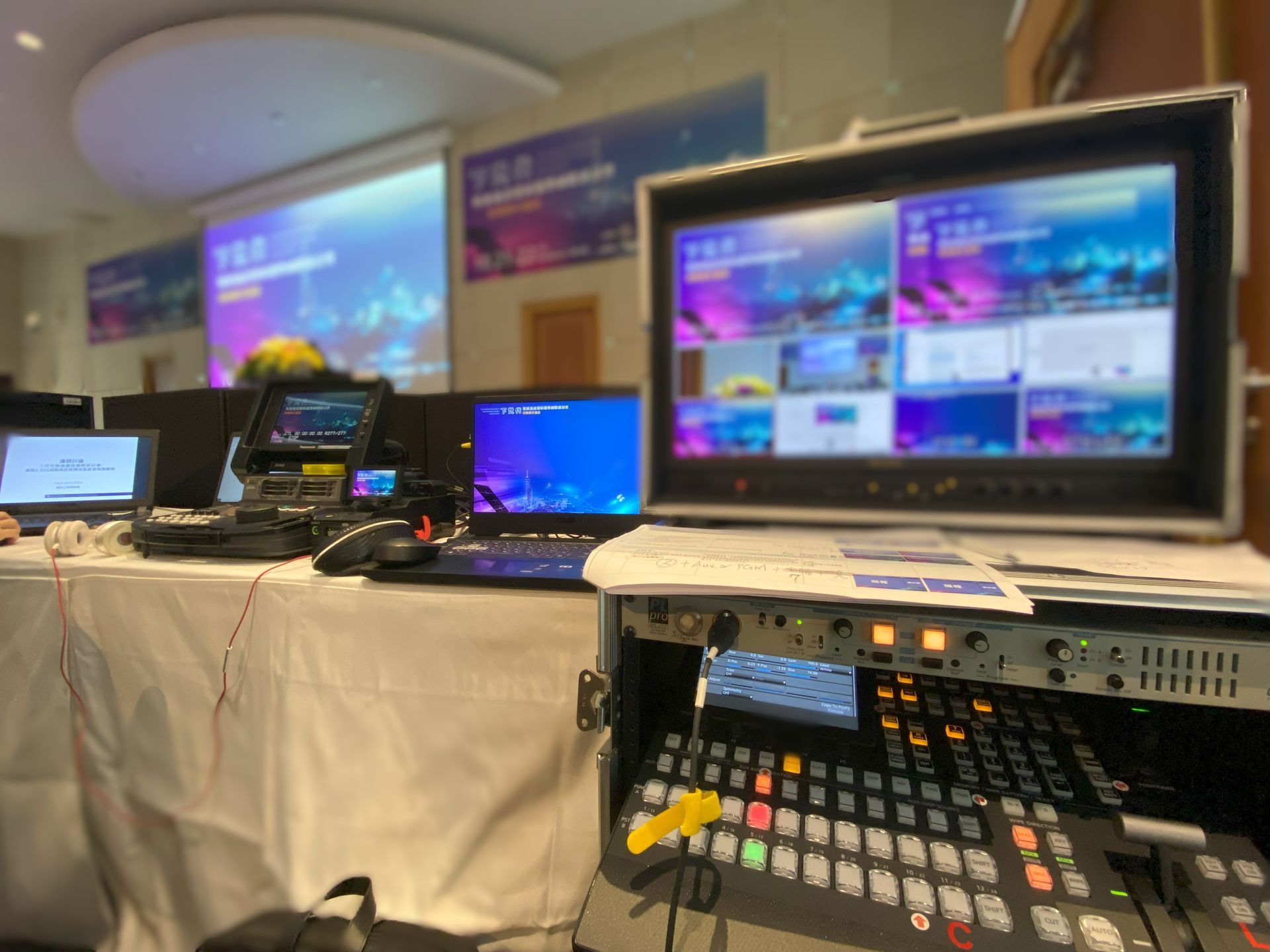 會議上的 AV 設備設定：顯示器、切換器、筆記型電腦和投影文字的螢幕。