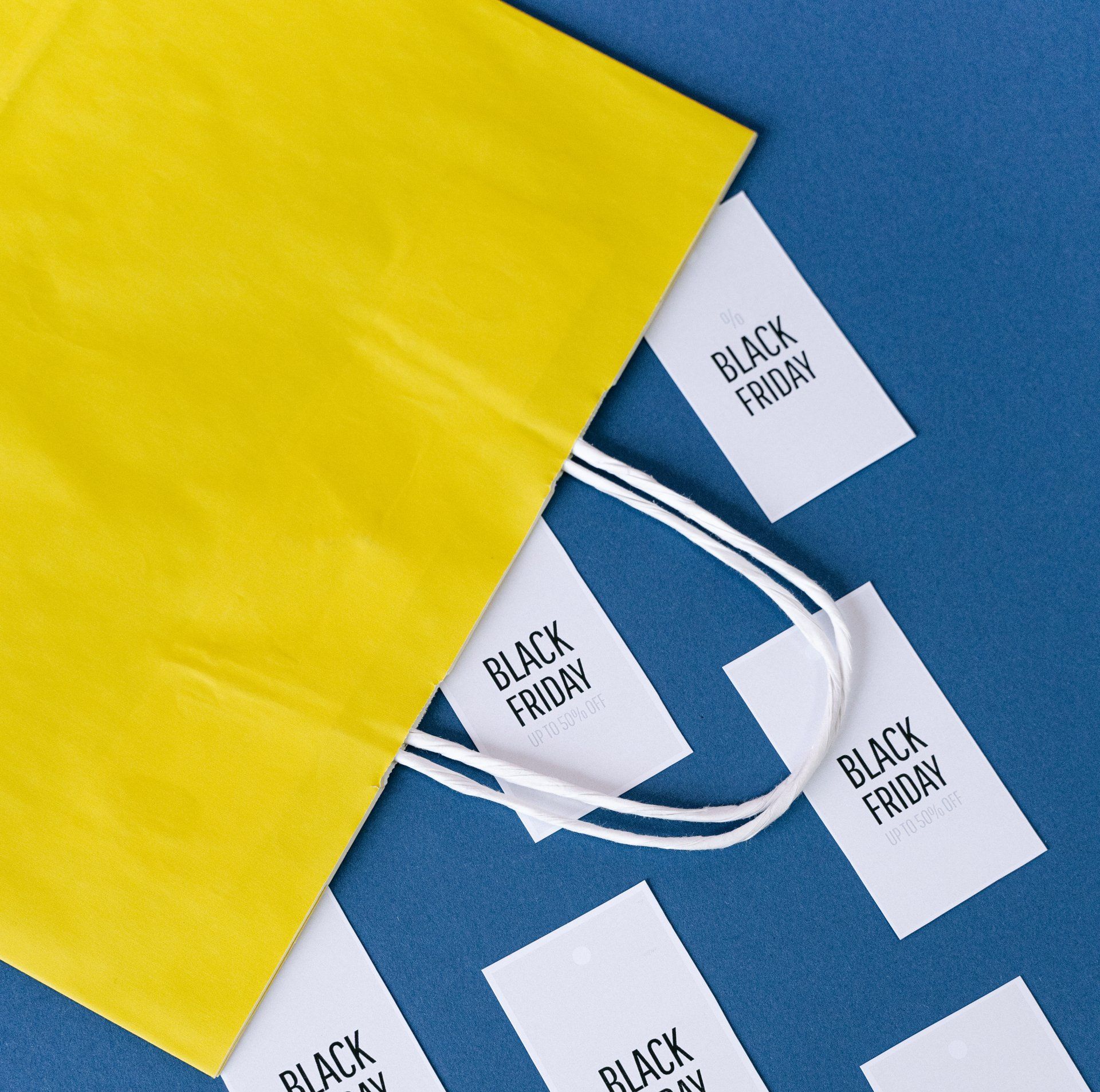 black friday sale 50% off flyers coming out of a yellow bag