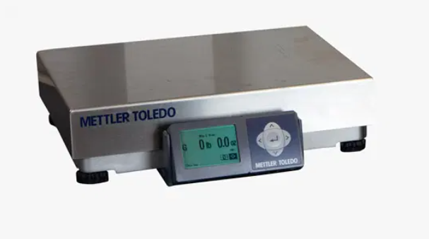 A mettler toledo scale is sitting on a white surface.