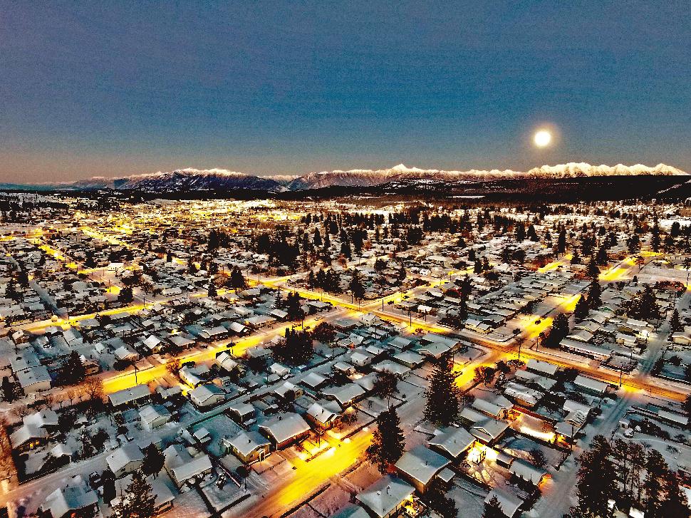 An aerial view of a snowy city at night