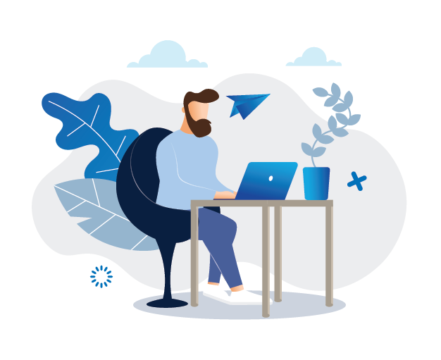 A man is sitting at a desk using a laptop computer.