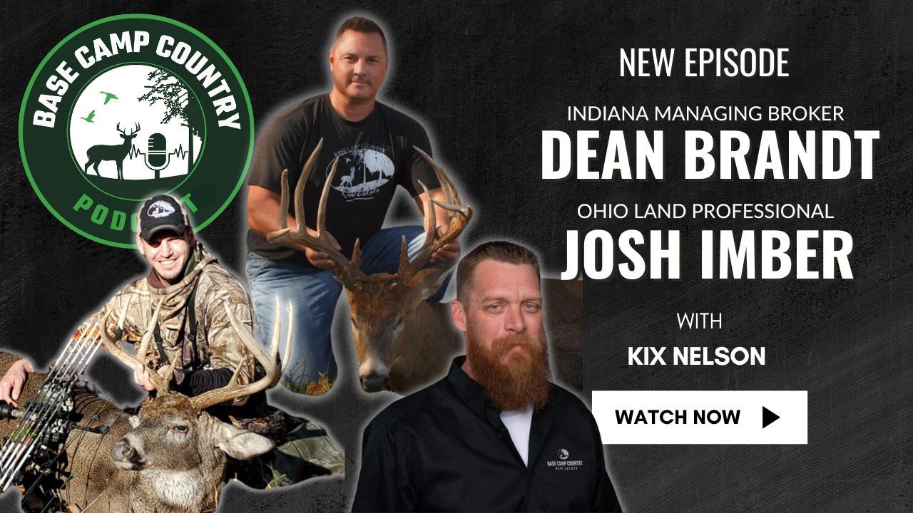 A man with a beard is holding a large deer.