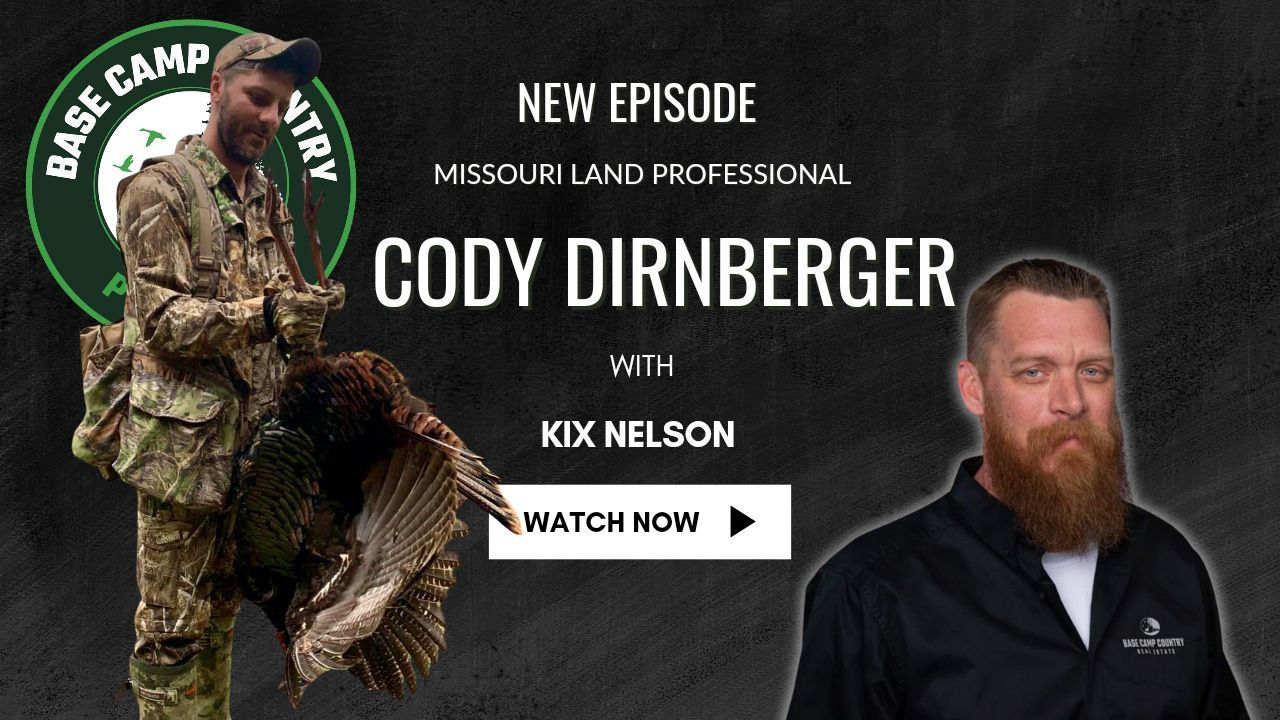 A man with a beard is holding a turkey in his hands.