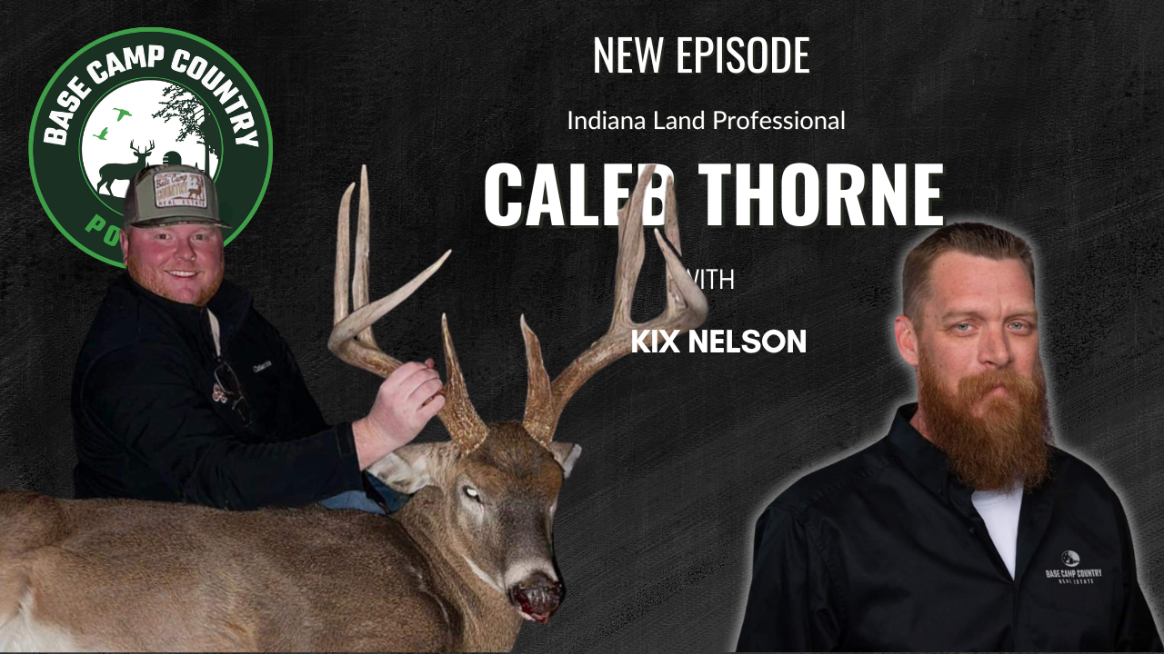 A man with a beard is standing next to a deer