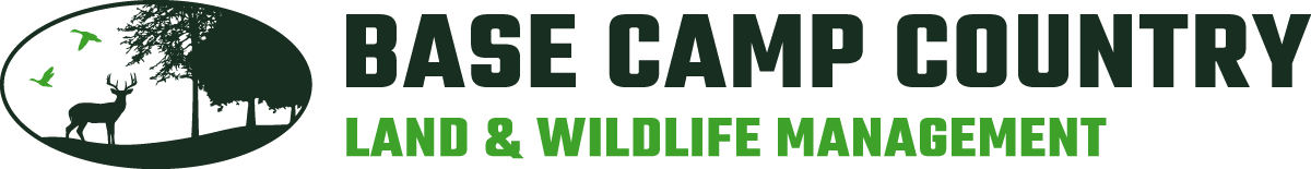 A logo for base camp country land and wildlife management