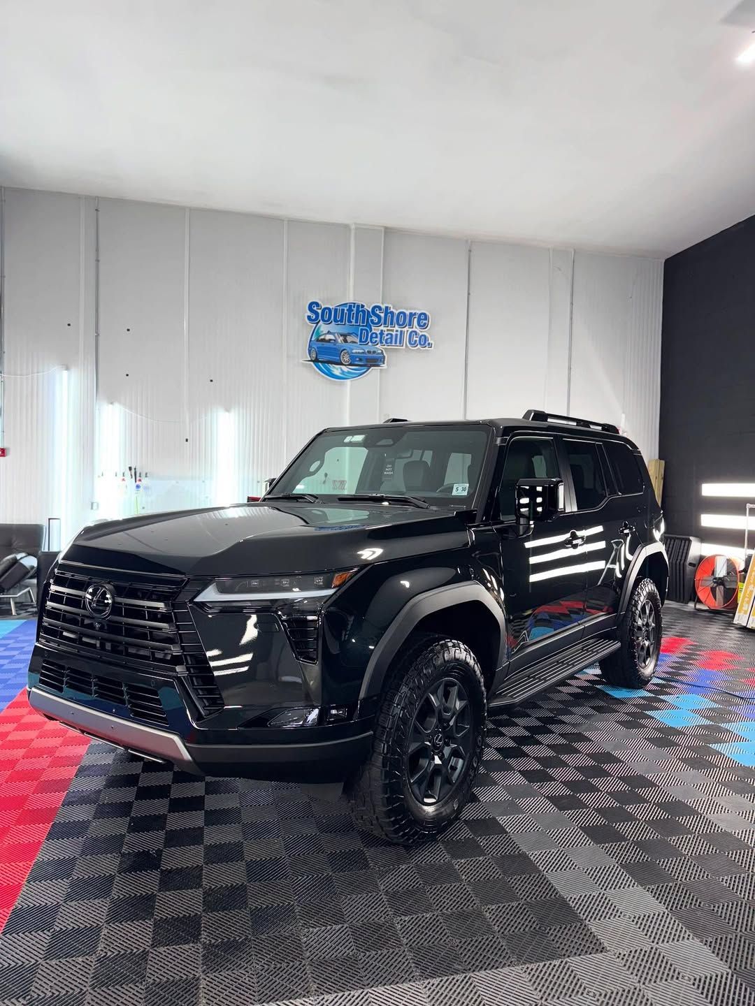 The inside of a boat with a steering wheel and a dashboard.