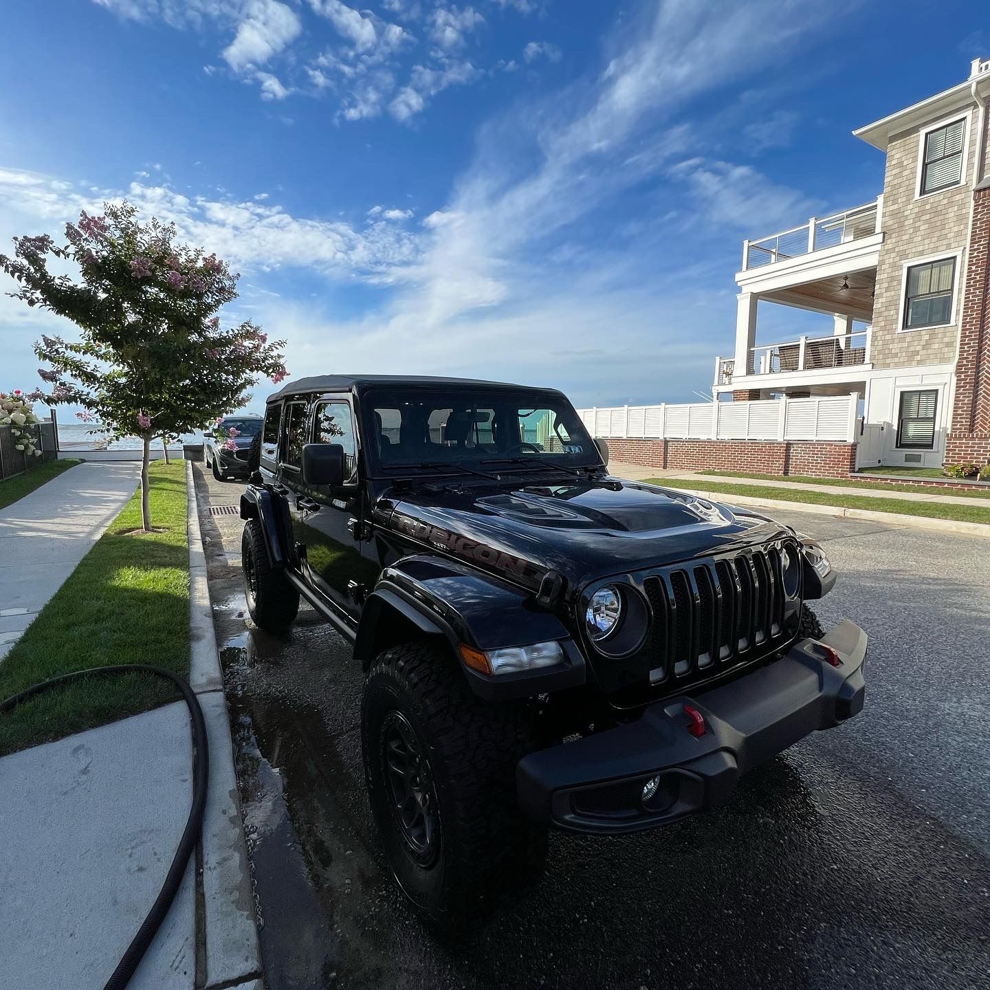 A black jeep is parked on the side of the road