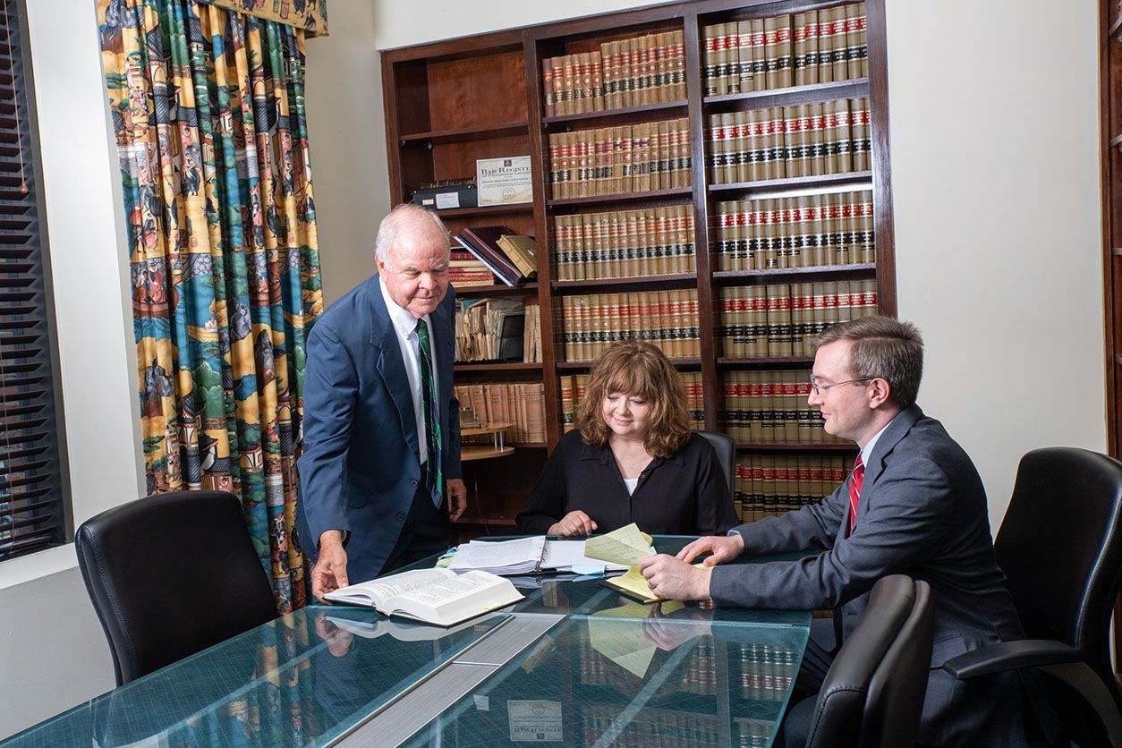 A group of people are sitting around a table in a conference room.