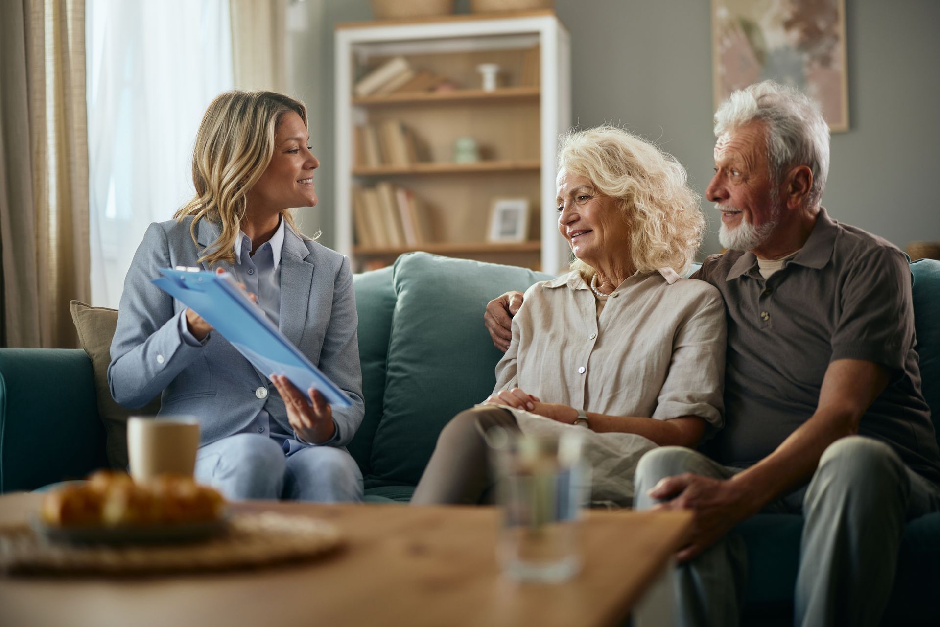 A lawyer talking to a senior couple during an estate planning meeting.