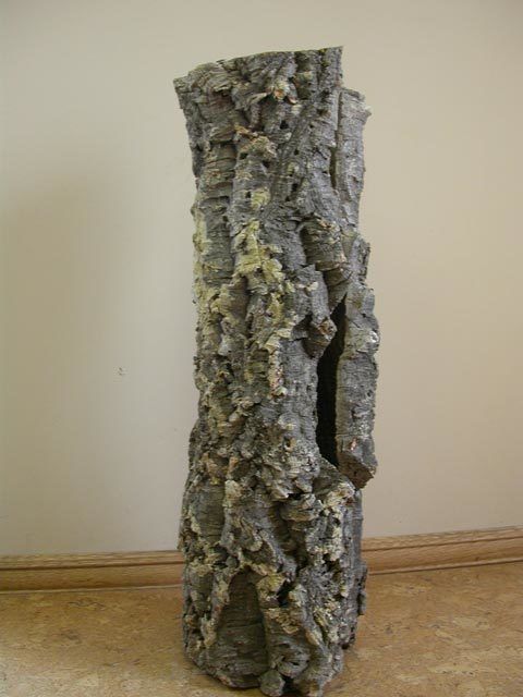 A sculpture of a tree trunk with a hole in the middle