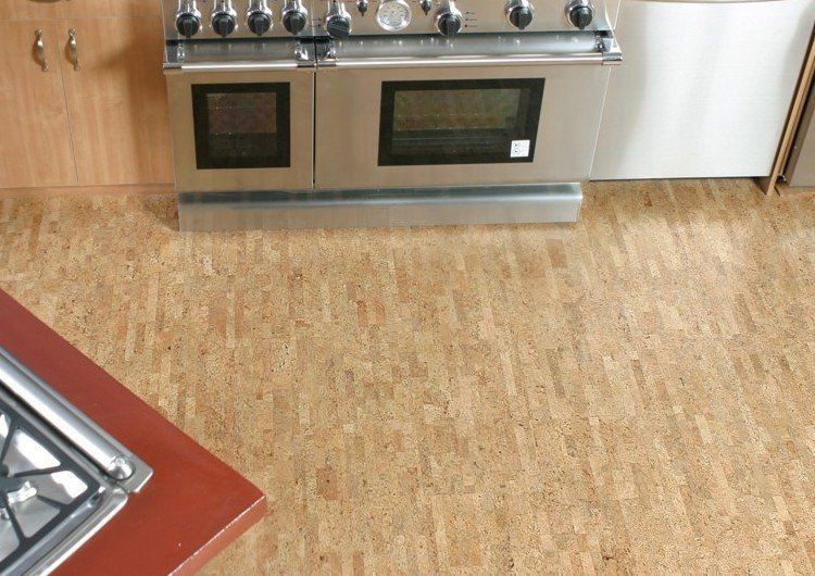 A kitchen with a cork floor and a stove top oven