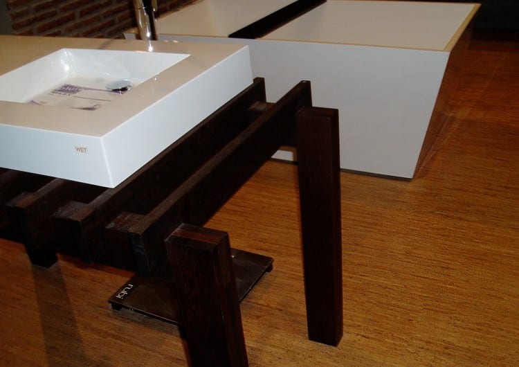 A wooden table with a sink on top of it