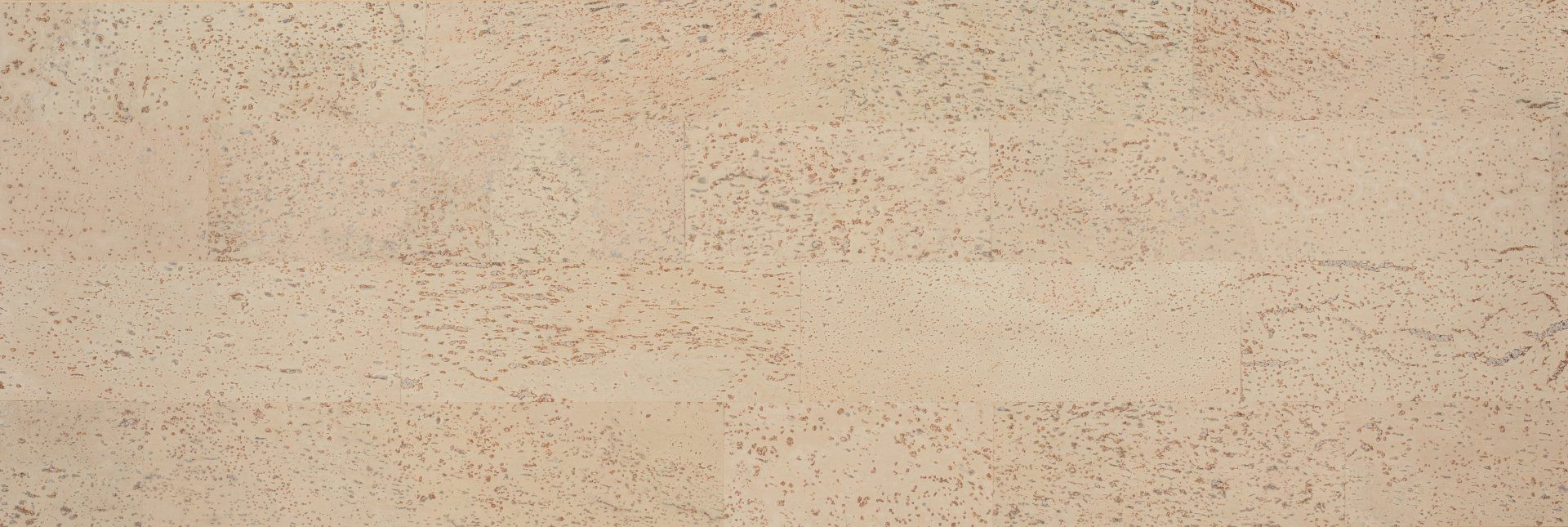 Un gros plan d'un mur beige avec une texture granuleuse.