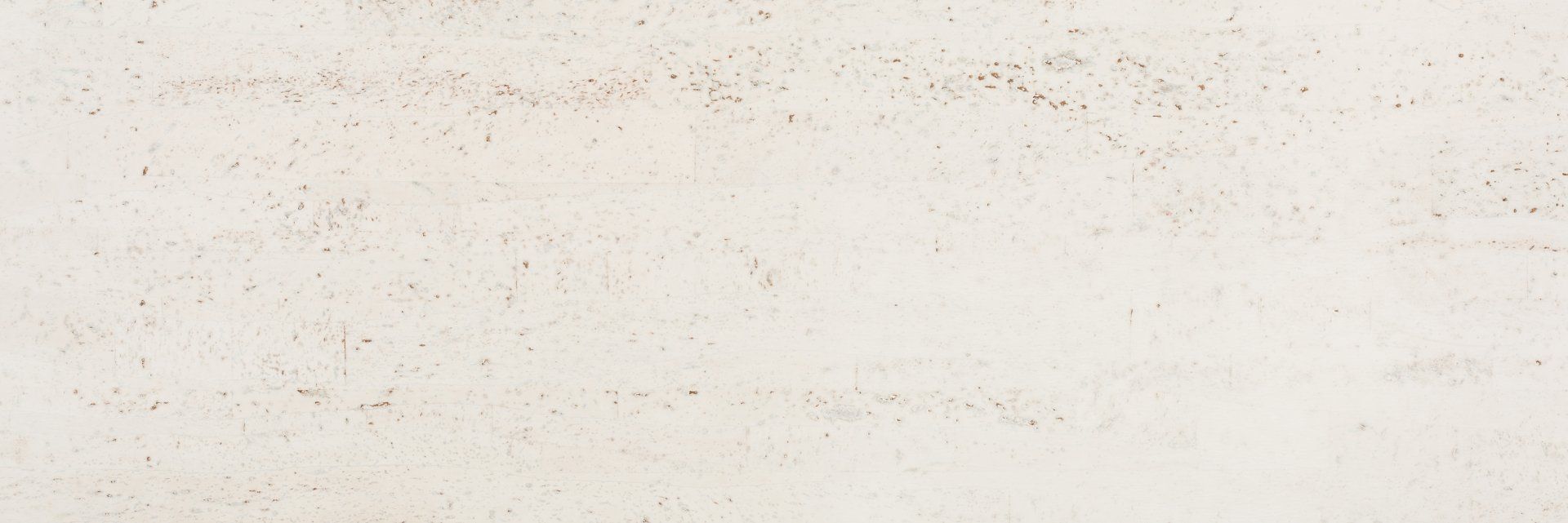 A close up of a white wall with a grainy texture.