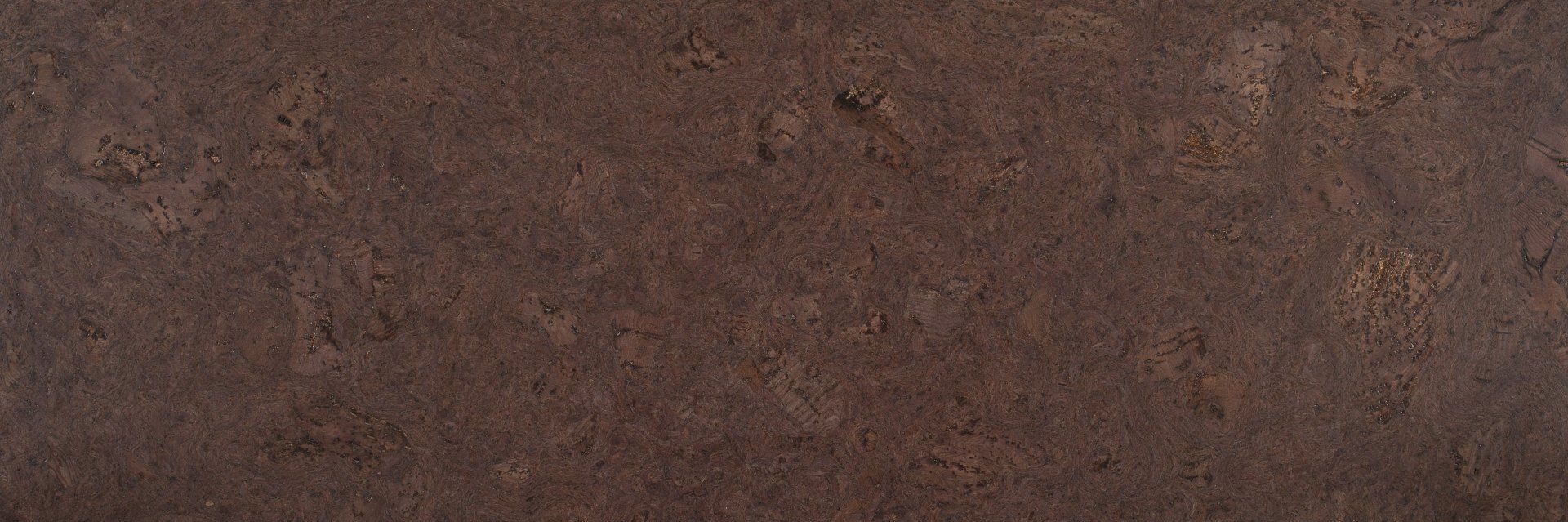Un gros plan d'une surface brune avec une texture granuleuse.