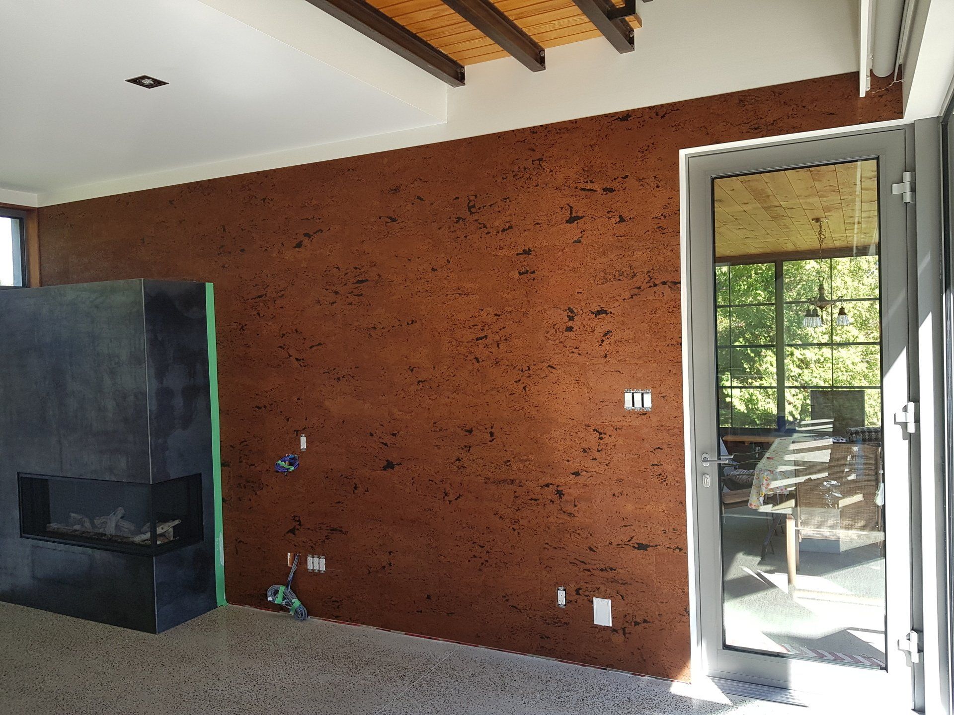 A living room with a fireplace and a large window