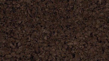 A close up of a pile of brown gravel.