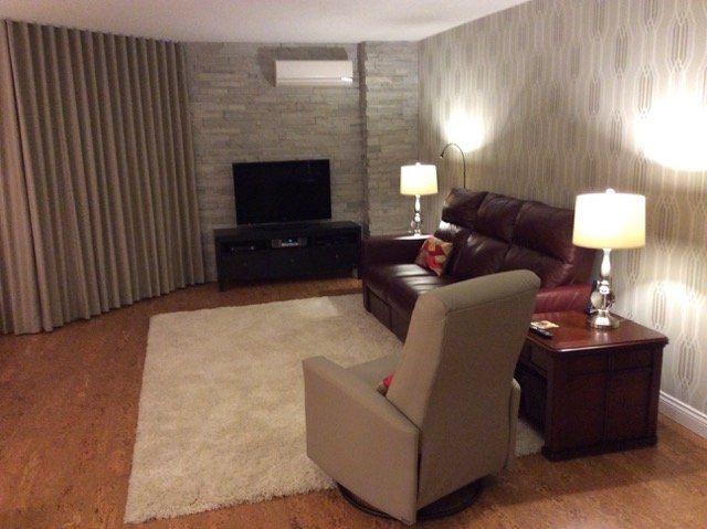 A living room with a couch a chair and a television