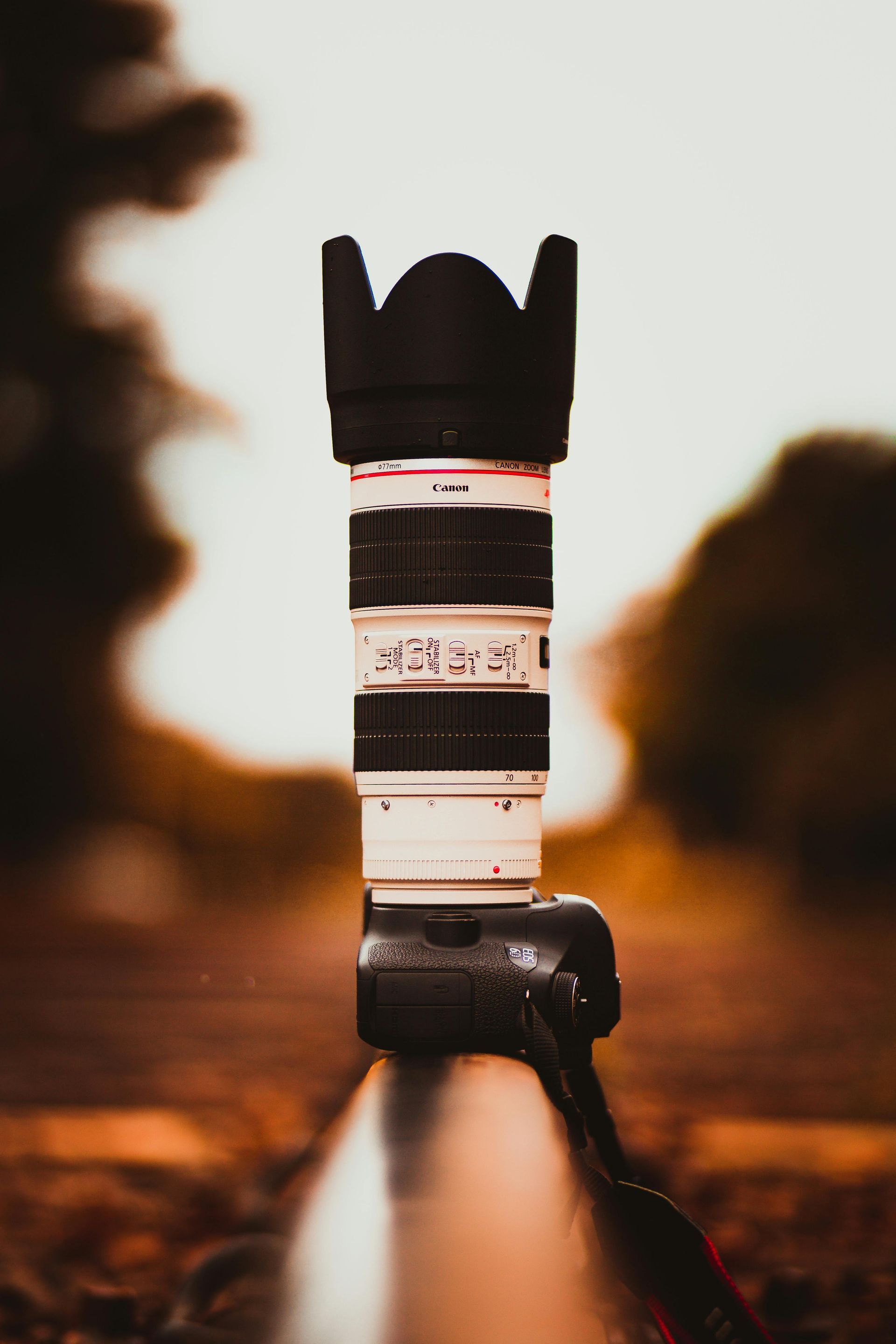 A camera lens is sitting on top of a tripod.