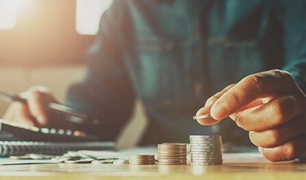 Man Holding Coin — Propane Gas in Delta, CO Man Holding Coin — Propane Gas in Delta, CO