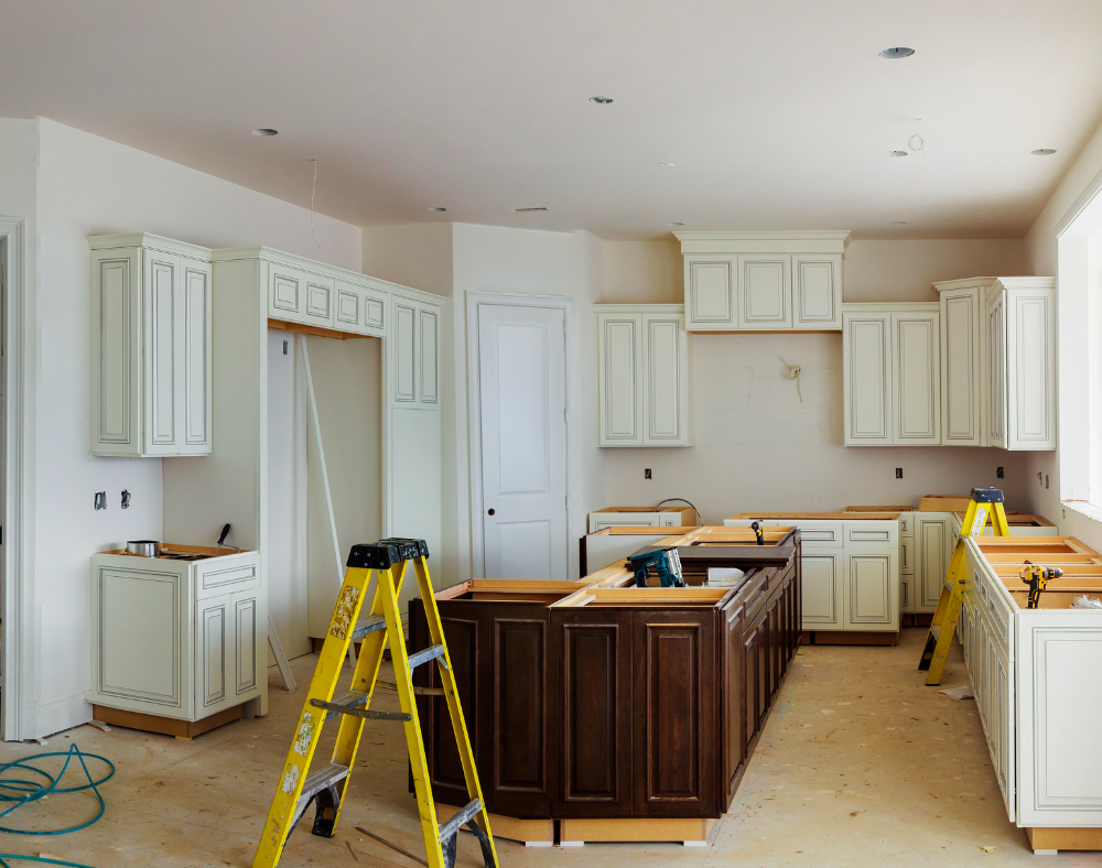 A kitchen under construction with a yellow ladder in the middle.