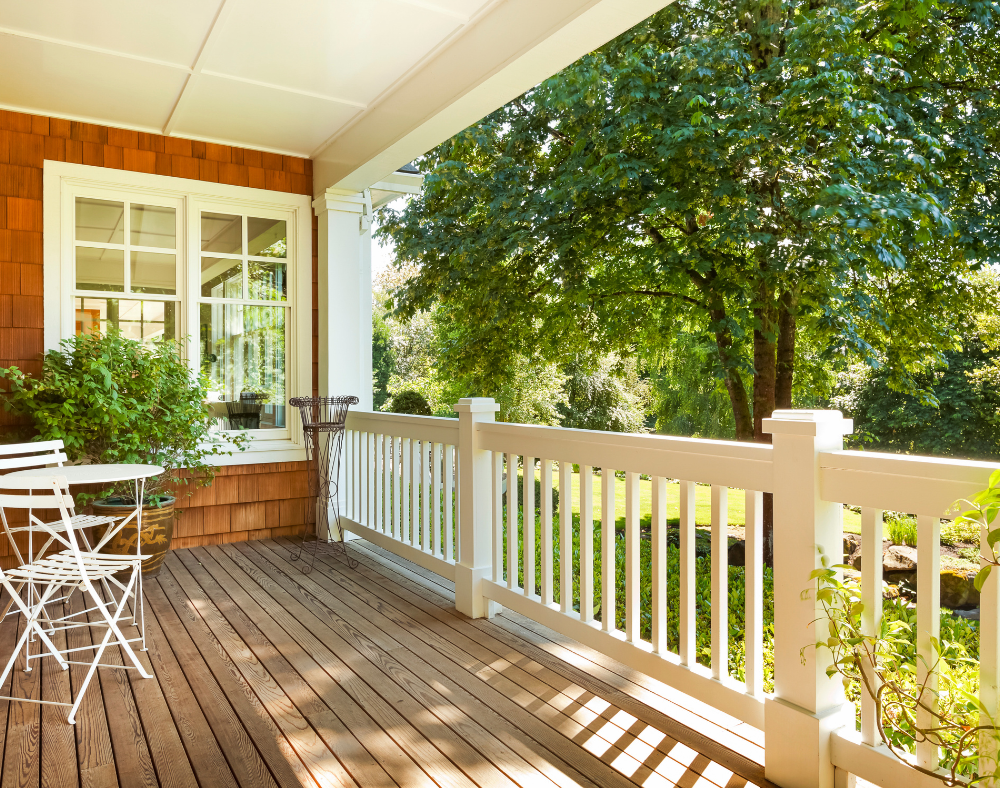 Charming, budget-friendly porch design with seating, plants, and string lights.