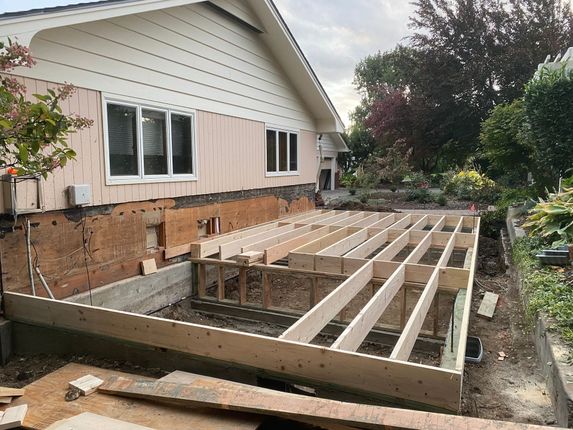 A house is being remodeled and a wooden deck is being built.