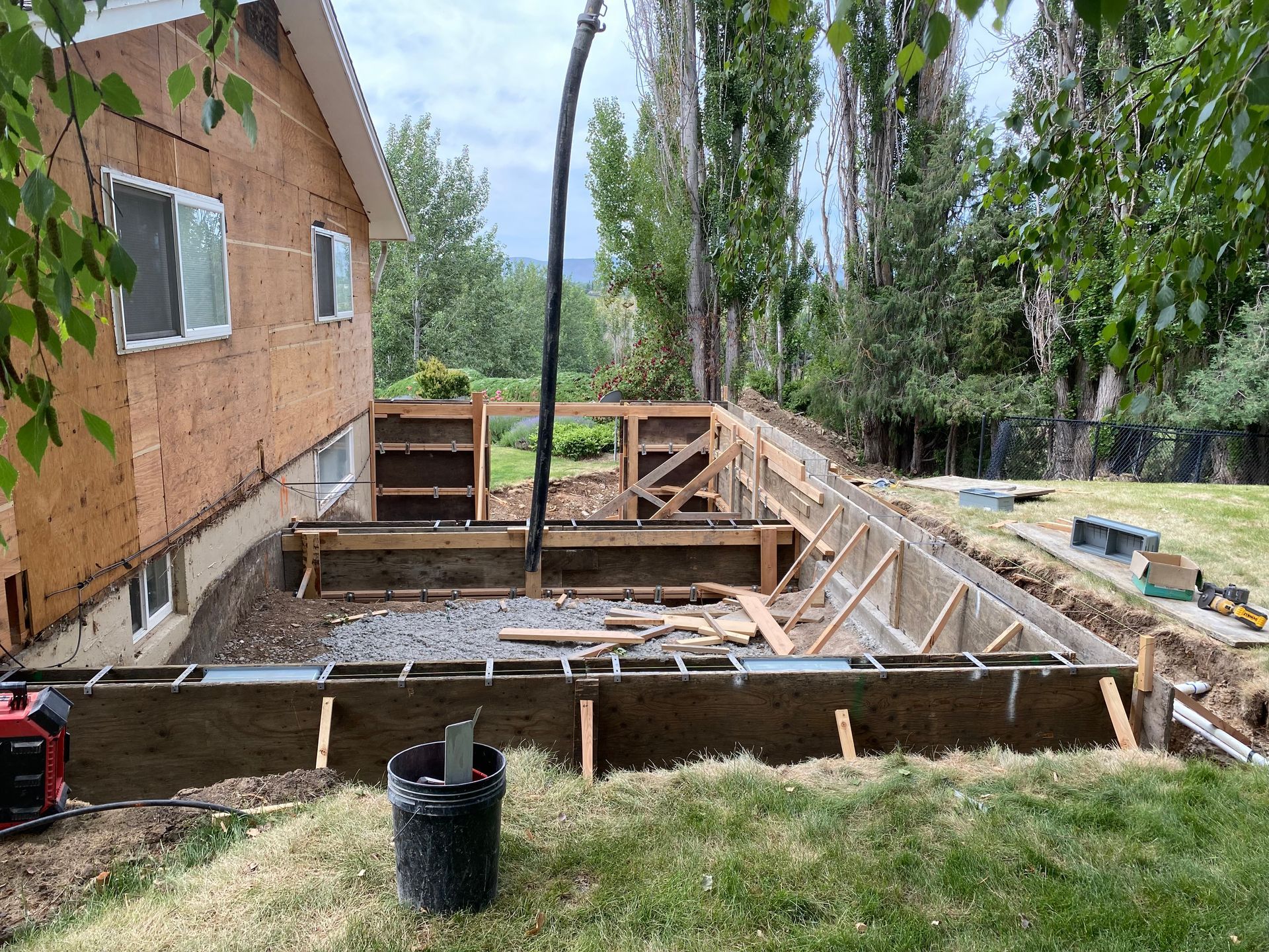 A house is being built in the backyard of a house.