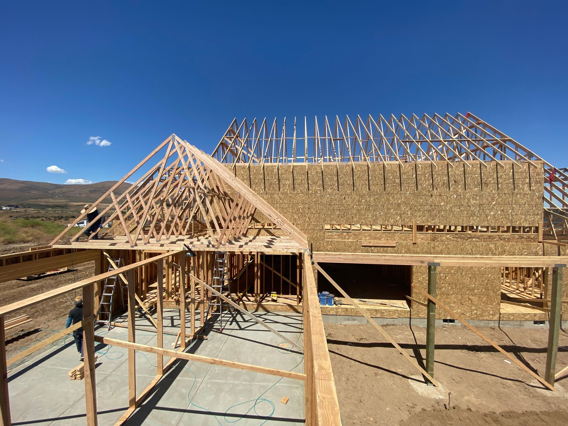 A house is being built with a blue sky in the background
