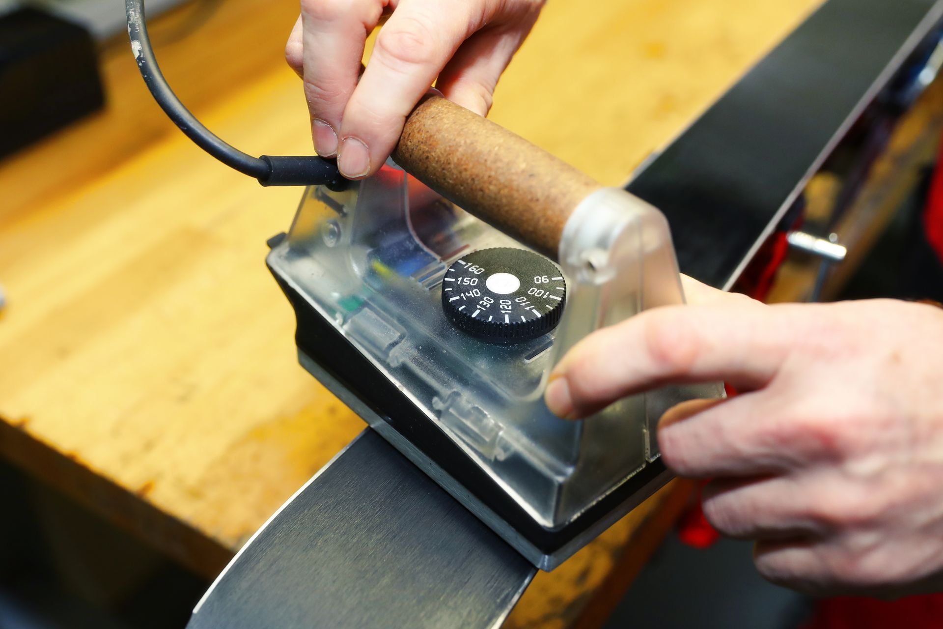A person is using an iron to polish a ski
