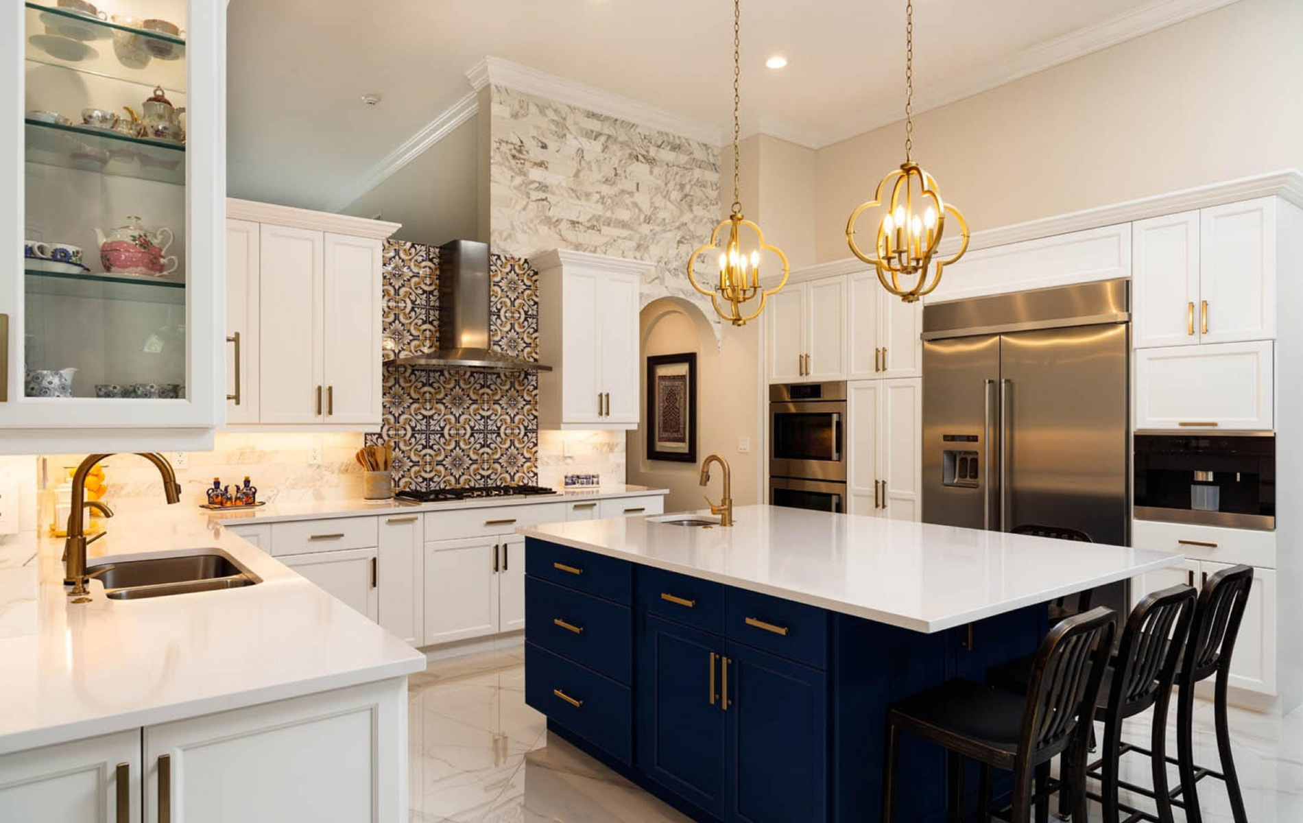 A kitchen with white cabinets , blue cabinets , stainless steel appliances and a large island.