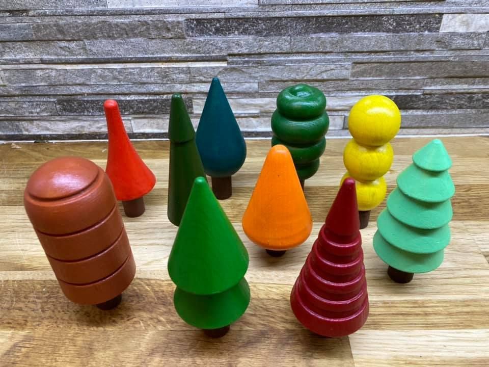 A group of wooden trees are sitting on a wooden table