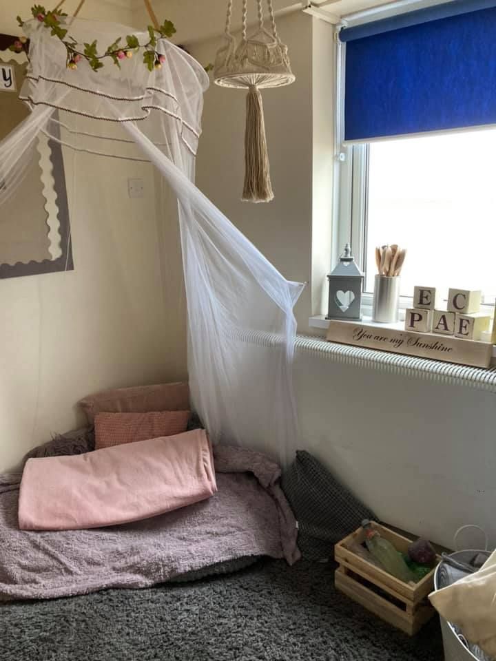 A bedroom with a canopy over a bed and a window.