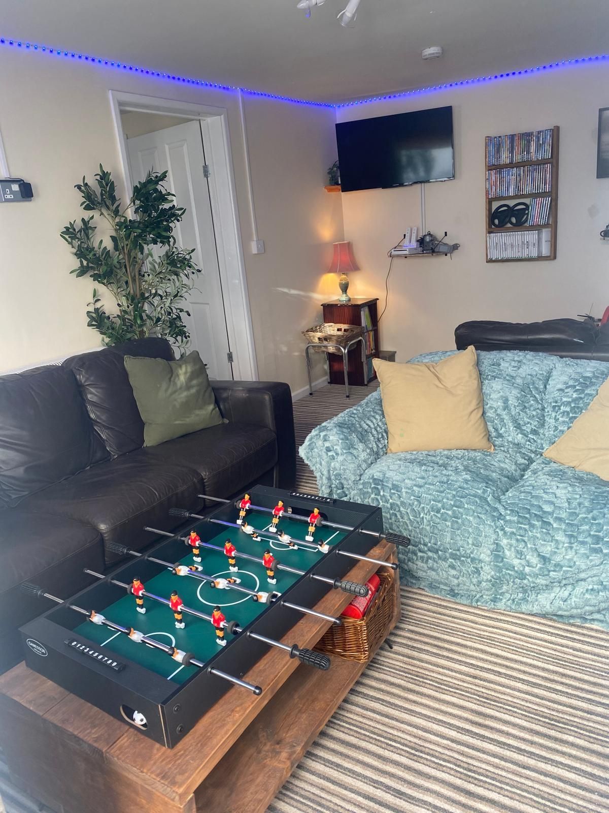A living room with a couch and a foosball table