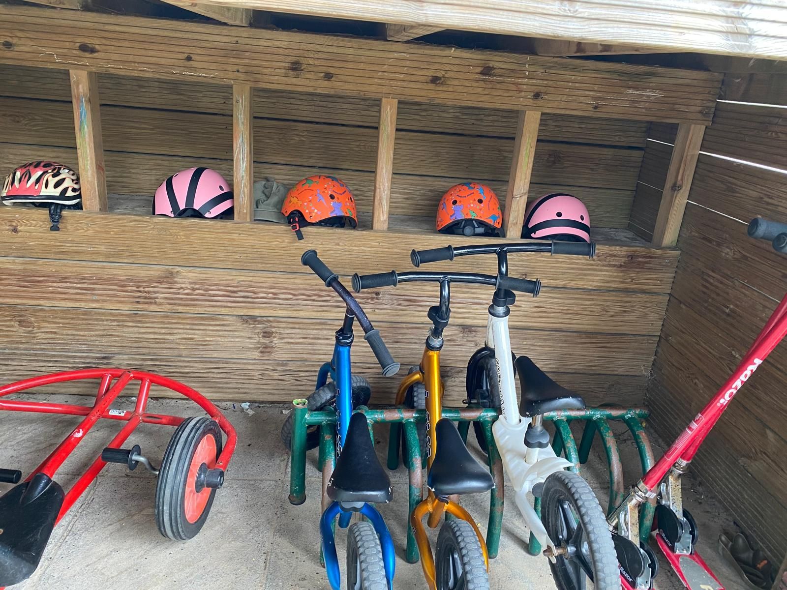 A row of bikes are lined up in a wooden shed