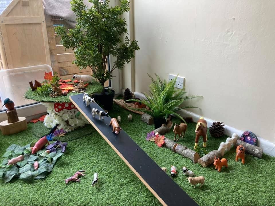 A room filled with toys and plants and a skateboard.