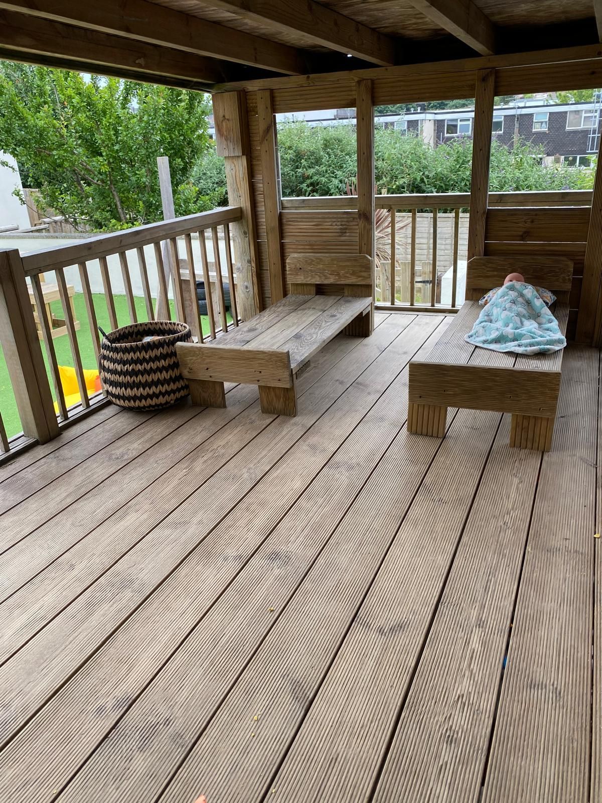 A wooden deck with a table and chairs on it