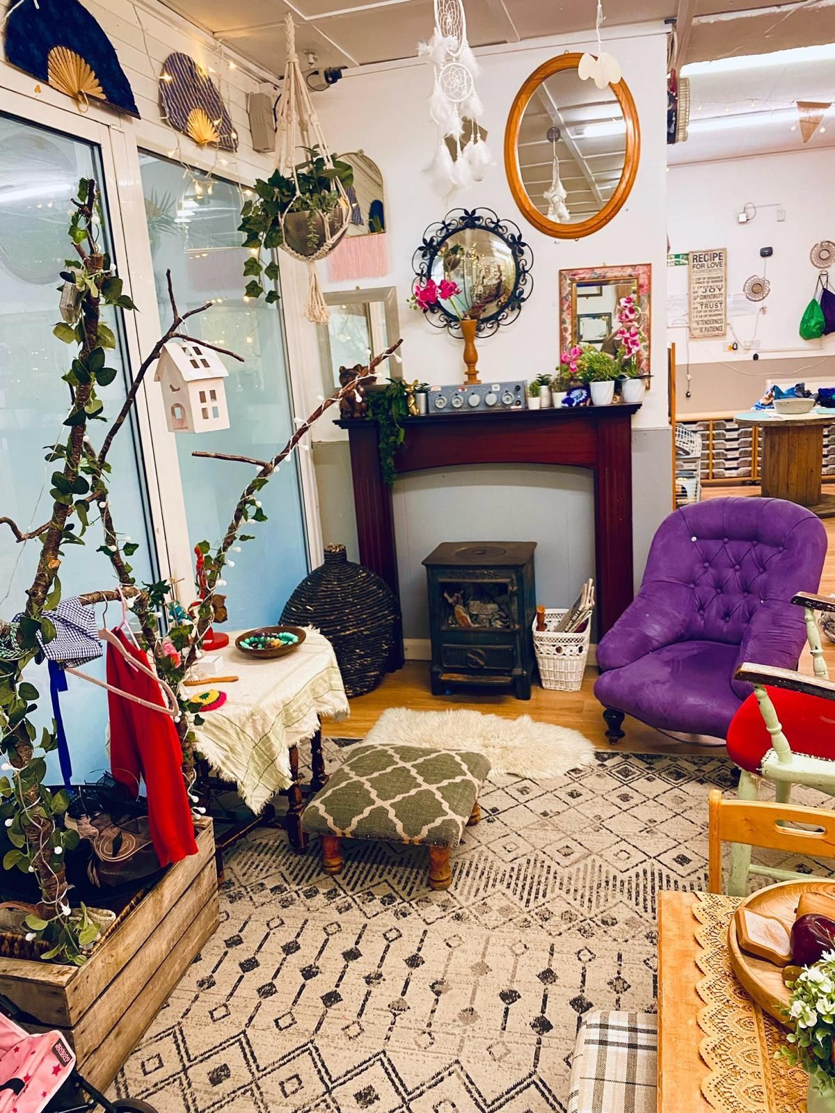 A living room with a fireplace and a purple chair