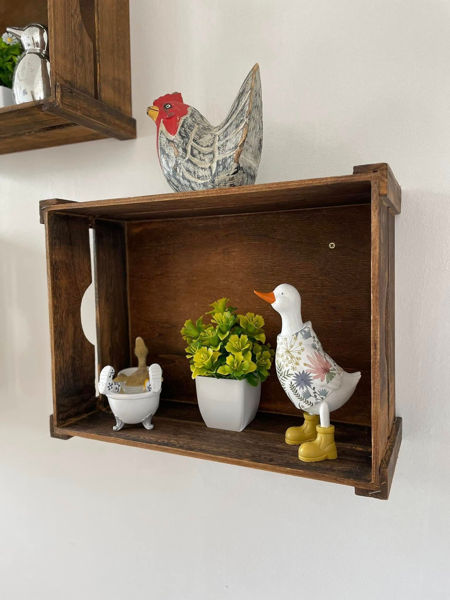 A shelf with a chicken and a duck on it