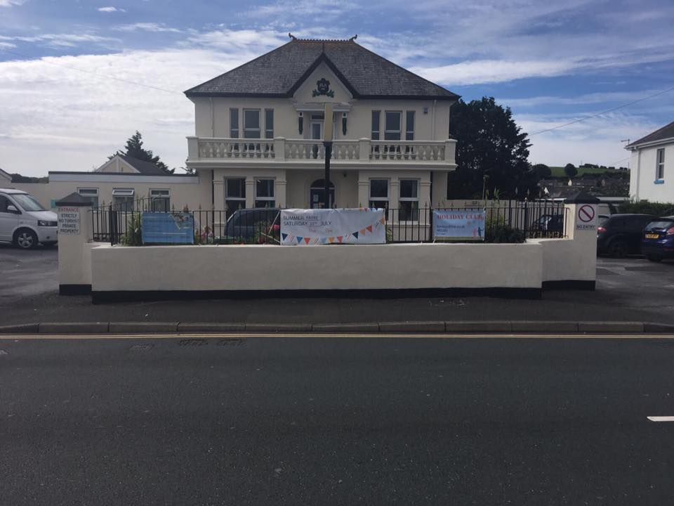 A large white building with a balcony and a sign that says happy birthday