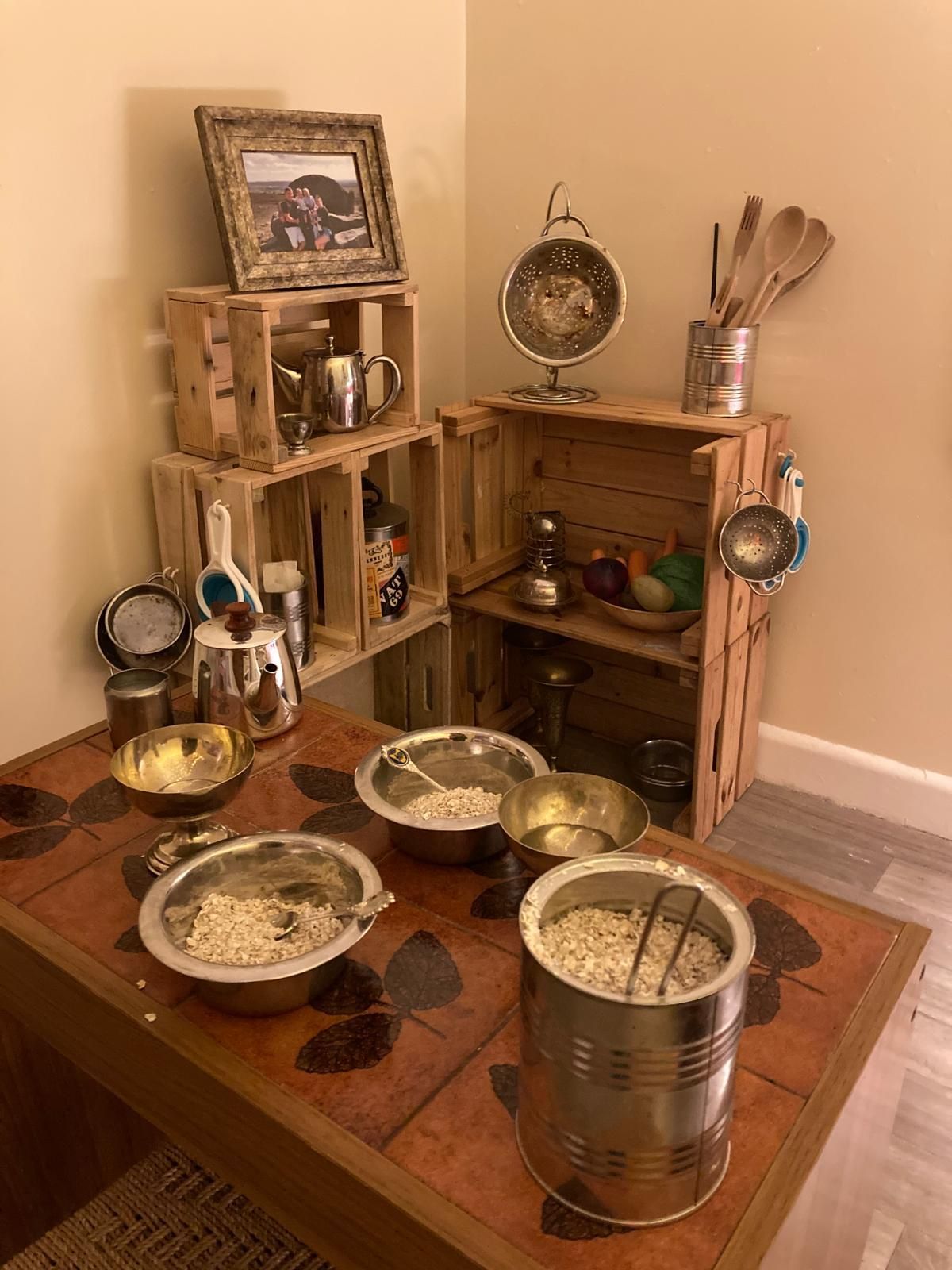 A table with bowls of food and utensils on it.